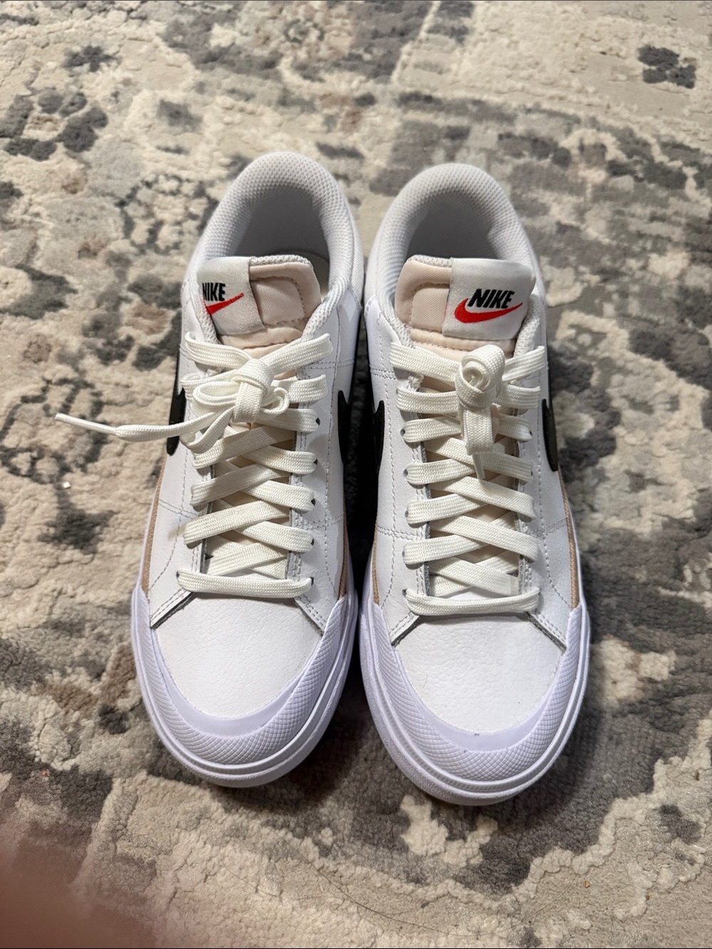 Nike Women's White Sneakers with Black Swoosh and Red Logo